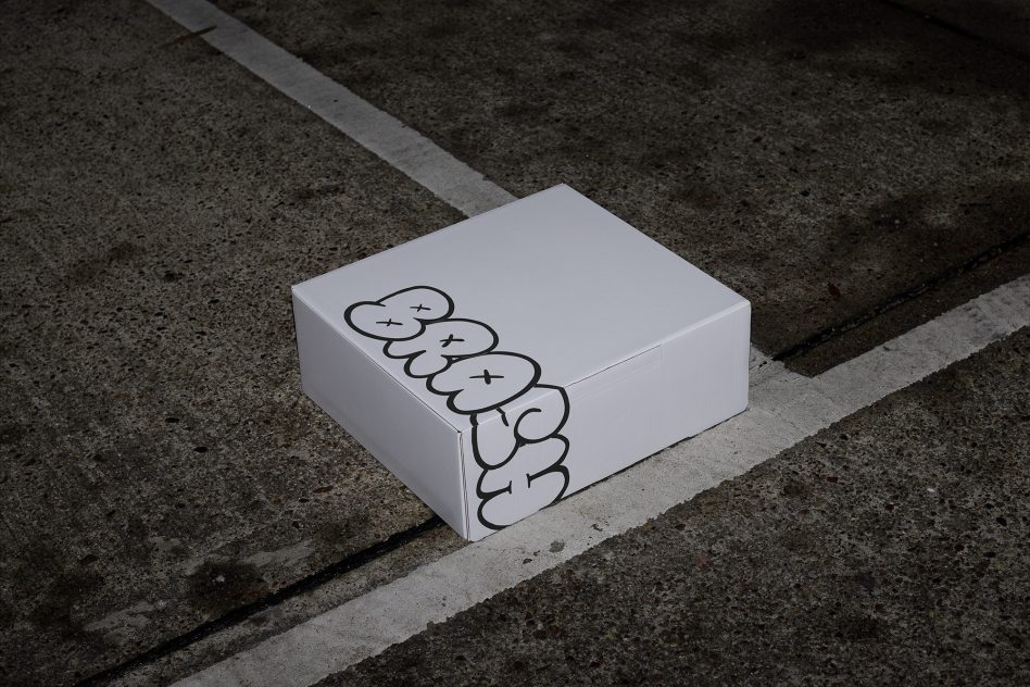 White square box with simple outline illustration on concrete